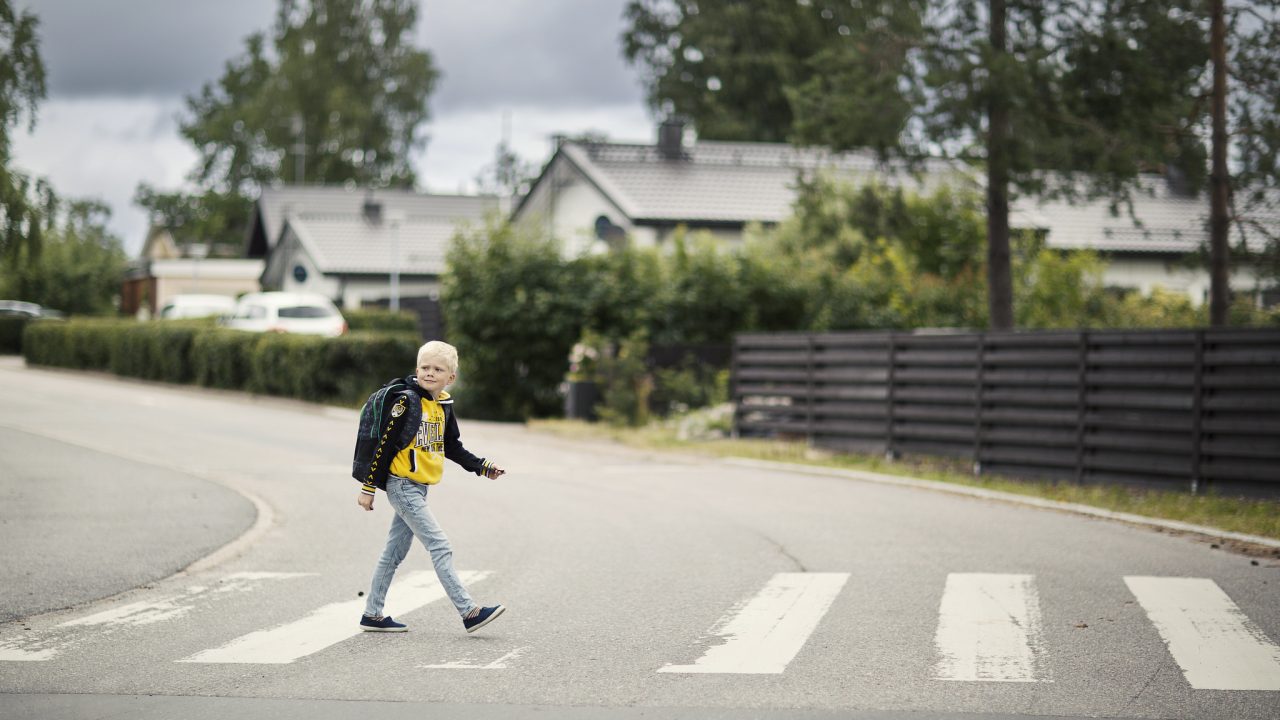 Koululainen ylittämässä suojatietä.