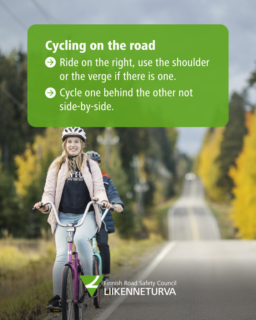 Two cyclists riding one behind the other.