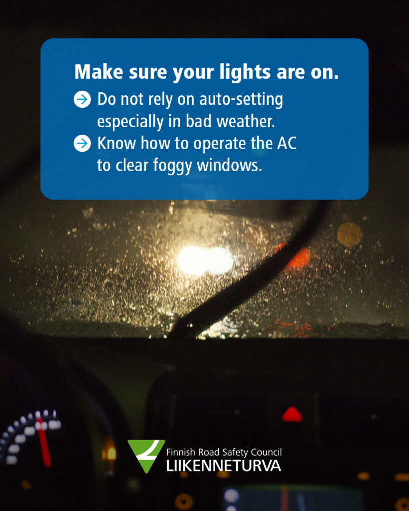 A rainy view through a windshield.